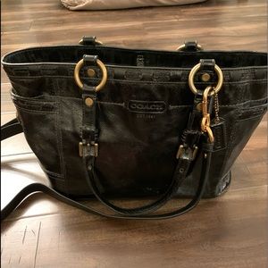 A very cute black coach bag